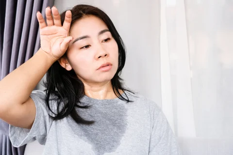 a portrait of a woman sweating excessively and undergoes Botox treatment for hyperhidrosis